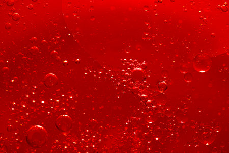 Water bubble texture on red backgroundの写真素材