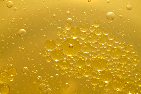 Oil bubble texture on gold background.の写真素材