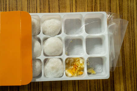 Daifuku Sweets in a square plastic box on a wooden floorの写真素材