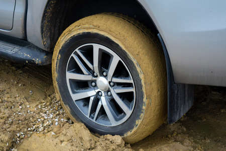 Car wheels stuck in mudの写真素材