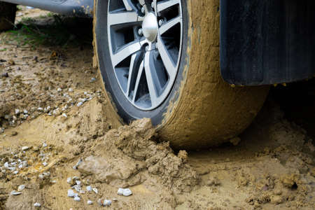 Car wheels stuck in mudの写真素材