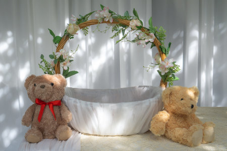 Basket wrapped with white cloth There are flowers around the handle. And a teddy bear besideの写真素材
