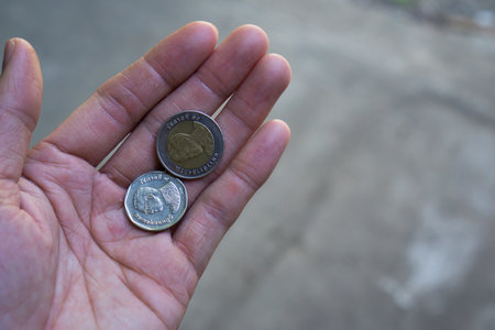 Silver coins of thailand In the hands of Asian menの写真素材