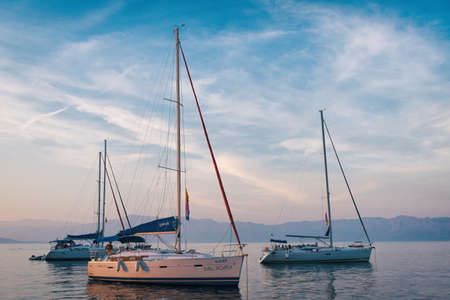 Sailing sunset on adriatic sea Makarska Korcula Croatia. Yacht in marina, sailing in Croatia.
