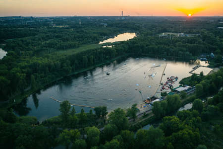 Wake cable park on lake Wakeboarding in the city aerial drone photo