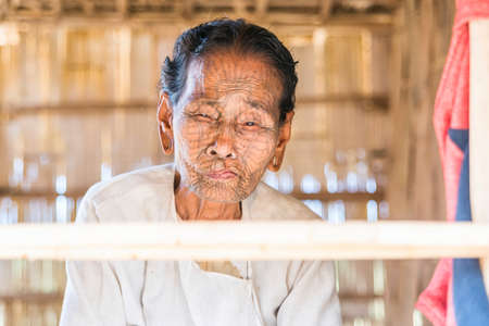 MRAUK U, RAKHINE STATE / MYANMAR - 7 December 2015: Portrait of an old Chin woman with a tattoo on her face Mrauk U, Myanmar Asiaのeditorial素材