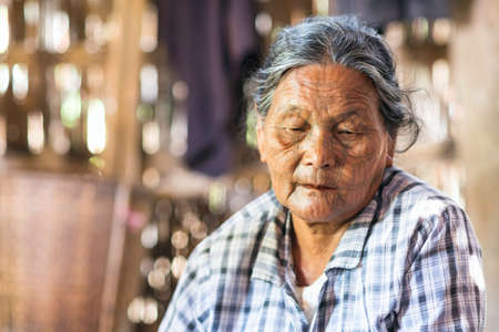MRAUK U, RAKHINE STATE / MYANMAR - 7 December 2015: Portrait of an old Chin woman with a tattoo on her face Mrauk U, Myanmar Asiaのeditorial素材