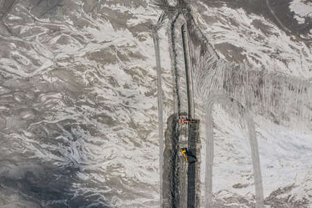 Excavator working on Industrial mine, abstract sendimentation tank of copper mine, turquoise water...