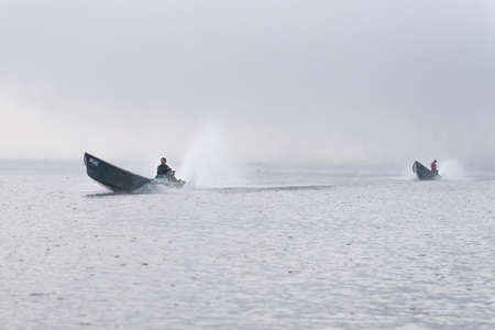 Traditional fisherman on a boat on Inle Lake Myanmar Burma in Asiaの写真素材