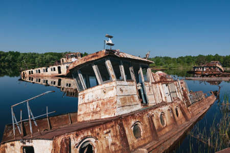 Abandoned sunken Barges Boats On River Pripyat in Chernobyl exclusion Zone. Chernobyl Nuclear Power Plant Zone of Alienation in Ukraine Soviet Unionの写真素材