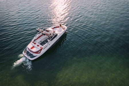 Wedding couple in a boat on lake, husband and wife outdoors aerial drone photo view