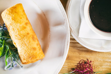 Red borscht with dumplings or a croquette on a plante. Dinner soup on a wooden table. Traditional polish famous cuisineの写真素材