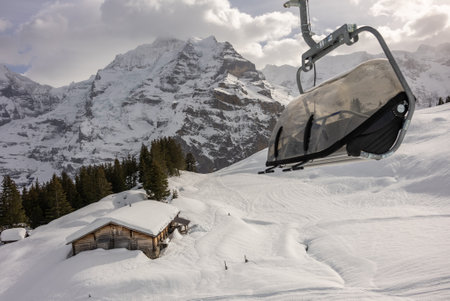 View of the Swiss mountains in winter. Eiger in clouds, Monoch and Jungfrau. Swiss alps in Jungfrauregion in Switzerlandの写真素材