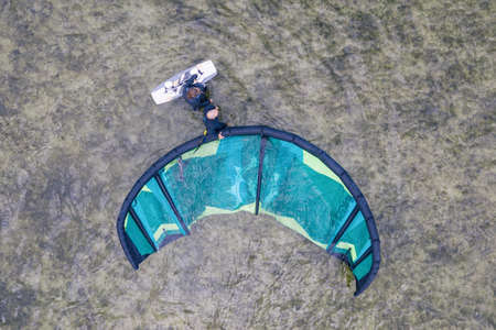 People swim in the sea on a kiteboard or kitesurfing. Summer sport learning how to kitesurf. Kite...