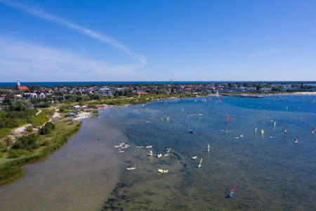 People windsurfing in the sea. Summer sport learning how to windsurf. Windsurf board on Puck bay in Jastarnia, Poland, Europe aerial drone photo viewのeditorial素材