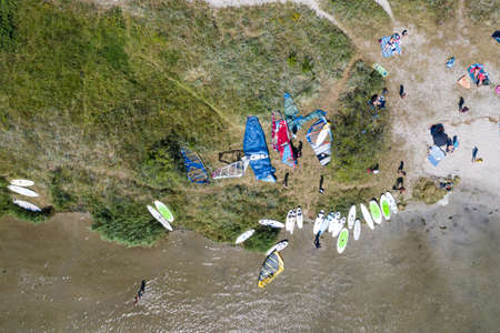 People windsurfing in the sea. Summer sport learning how to windsurf. Windsurf board on Puck bay in Jastarnia, Poland, Europe aerial drone photo viewのeditorial素材