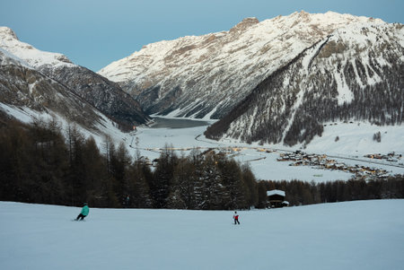 Snowcat on slope. Town of Livigno in winter. Livigno landskapes in Lombardy, Italy, located in the Italian Alps, near the Swiss borderの写真素材