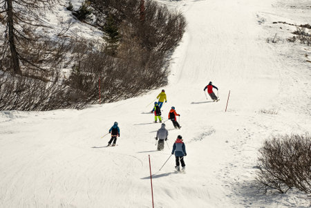 Group of people skiing in the mountains on a sunny winter day.の写真素材