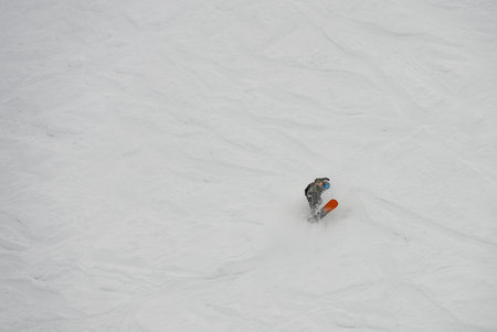 Freeride snowboarding in winter. Freeride heliboarding. Riding in powder on snowboard. Ski, snowboard freeride and deep powder snow. Gudauri Georgia Caucasus resort. Freeride in Caucasus mountains.の写真素材
