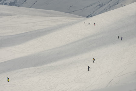Freeride snowboarding in winter. Freeride heliboarding. Riding in powder on snowboard. Ski, snowboard freeride and deep powder snow. Gudauri Georgia Caucasus resort. Freeride in Caucasus mountains.の写真素材