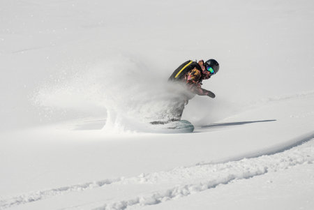 Freeride snowboarding in winter. Freeride heliboarding. Riding in powder on snowboard. Ski,...