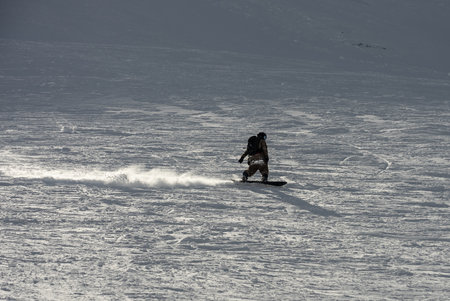 Freeride snowboarding in winter. Freeride heliboarding. Riding in powder on snowboard. Ski, snowboard freeride and deep powder snow. Gudauri Georgia Caucasus resort. Freeride in Caucasus mountains.の写真素材