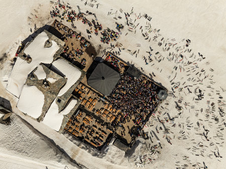 Aerial drone view of people enjoying apres-ski. Apres ski in a mountain chalet bar in les deux...