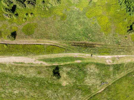 Drone view on trail in Beskid mountains, Blatnia. Summer green forest on Blatnia. Beskid mountains in Jaworze. Drone fly above green mountains and trail. Polish green mountains and hills aerial droneの写真素材