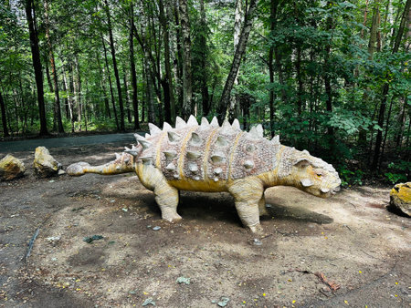 Realistic figure of an Sajchania dinosaur inforest park in Kazimierz Sosnowiec. Prehistoric predator create a fascinating element of the landscape, attracting dinosaur lovers. Sajchania dinosaur.の写真素材