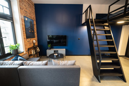 Modern studio apartment with a mezzanine bedroom. Stylish kitchen seamlessly connected to a cozy...