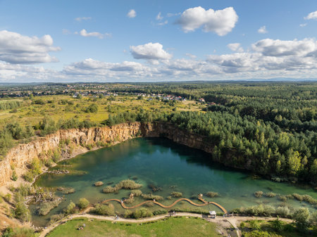 Aerial drone photo of Quarry turquiose lake colour, open pit mining in Park Grodek, Jaworzno. Poland. Turquiose Water and Wooden Bridge. Polish Maldives Park Grodek in Jaworzno from drone.の写真素材