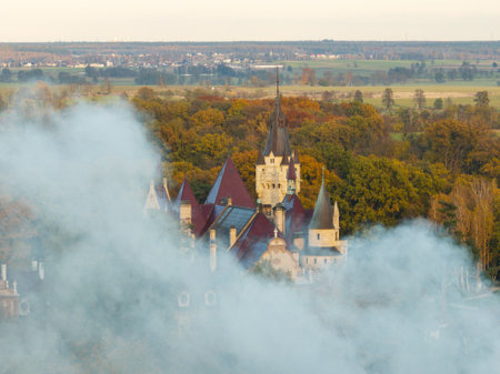 Aerial Drone Footage of Moszna Castle, Poland Stunning Views of the Majestic Neo-Gothic and Baroque Architecture Surrounded by Lush Gardens and Scenic Landscape in the Heart of Silesia. Moszna Castle.の写真素材