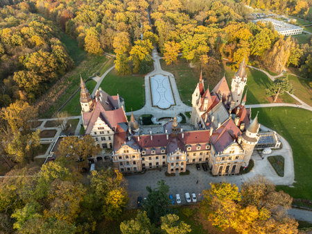 Aerial Drone Footage of Moszna Castle, Poland Stunning Views of the Majestic Neo-Gothic and Baroque Architecture Surrounded by Lush Gardens and Scenic Landscape in the Heart of Silesia. Moszna Castle.の写真素材