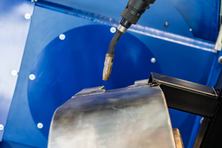 Robot welds steel. Welding head. Welding robot. CNC welding. Robotization and automation of the...