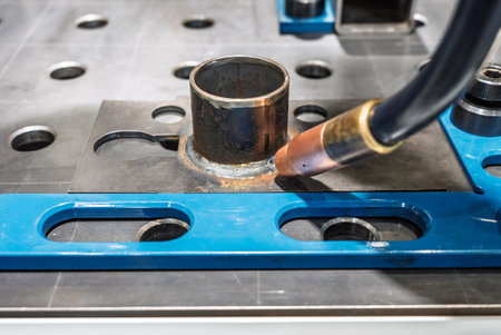 Robot welds steel. Welding head. Welding robot. CNC welding. Robotization and automation of the...