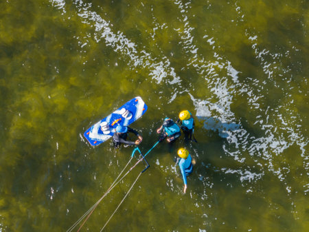 People swim on the sea on a kiteboard or kitesurfing. Summer sport learning how to kitesurf....