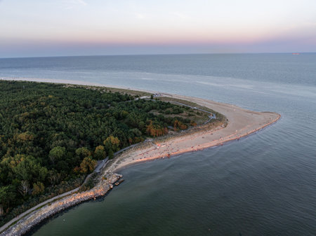 Aerial view of Hel Peninsula in Poland, Baltic Sea and Puck Bay. Aerial video made by drone from above. End of poland hel peninsula. Hel beach in Poland. Sunset at sea and bay, Poland.の写真素材
