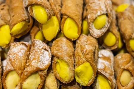 Cannoli, Sicilian pastry consisting of a tube shaped shell of fried pastry dough, filled with a sweet, creamy filling containing ricotta cheese. Italian cannolo and Sicilian cannoluの写真素材