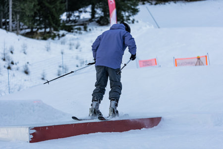 Snow park box tricks. Skiers in park on a box. Winter jibbing in snwopark. Ski lessons on snowpark....