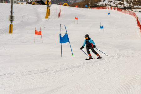 Group of people skiing in the mountains on a sunny winter day. Ski lessons with local instructors. Children learn to ski with an instructor. Children's skiers in the Dolomites Alps.の写真素材