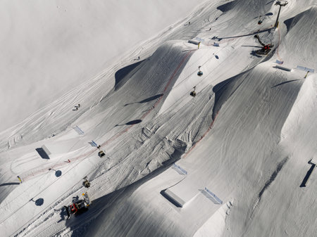 Aerial drone view of snowpark in dolomites, alps. Madonna di Campiglio winter ursus snowpark in Val Rendena trentino Italy. Ski and snowboard tricks on kickers, obstacle in the snow park.の写真素材