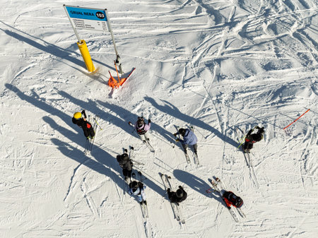Aerial drone view of group of skiers getting ready for a winter descent. Group of skiers in the mountain. Sunny winter day in the dolomites.の写真素材
