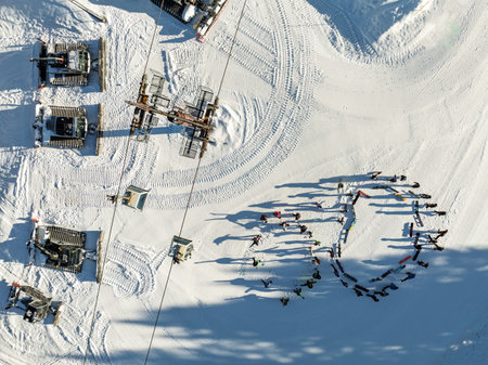 Winter warm up on snow in mountains. Aerial drone view of warm up in sunny winter in dolomites, alps. Warm up before ski snowboard riding. Pinzolo in Val Rendena dolomites trentino Italy.の写真素材