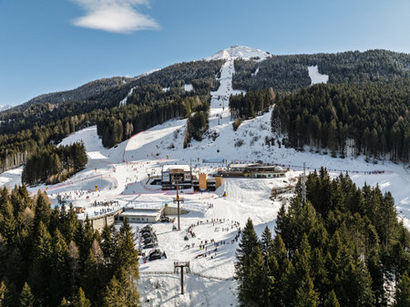 Aerial drone view of sunny winter in dolomites, alps. Pinzolo village and a ski resort in Italy. Dolomites Brenta, Adamello park Presanella moutain, Doss del Sabion skiarea trentino Italy.の写真素材