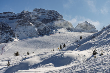 Aerial drone view of sunny winter in dolomites, alps. Pinzolo village and a ski resort in Italy. Dolomites Brenta, Adamello park Presanella moutain, Doss del Sabion skiarea trentino Italy.の写真素材