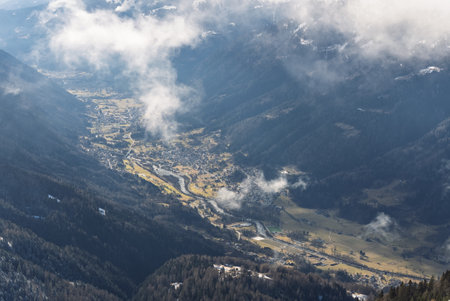 Aerial drone view of sunny winter in dolomites, alps. Pinzolo village and a ski resort in Italy....