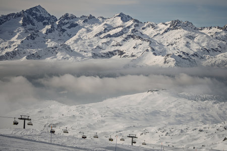View of sunny winter in dolomites, alps. Village covered in fog and clouds a ski resort in Italy. Ursus snowpark in Val Rendena dolomites trentino Italy.の写真素材