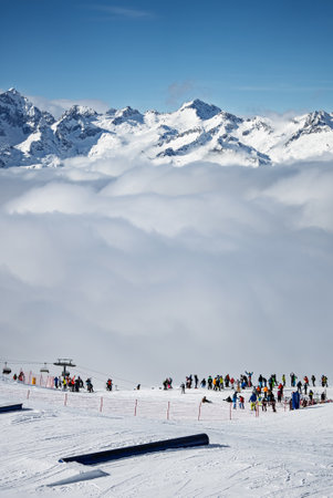 View of sunny winter in dolomites, alps. Madonna di Campiglio village covered in fog and clouds a ski resort in Italy. Madonna di Campiglio snowpark in Val Rendena dolomites trentino Italy.の写真素材