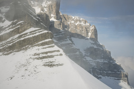 View of sunny winter in dolomites, alps. Madonna di Campiglio village covered in fog and clouds a...