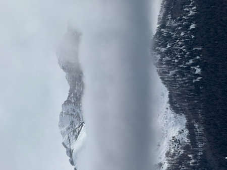 View of sunny winter in dolomites, alps. Madonna di Campiglio village covered in fog and clouds a...